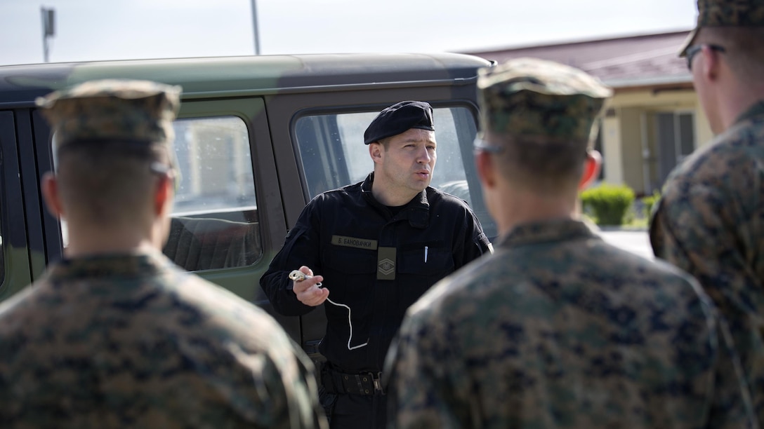 Warrant Officer Branislav Banovacki, a counter terrorism military police technician with Special Brigade, Serbian Armed Forces, shows Marines how to conduct a search for improvised explosive devices in a car during exercise Platinum Wolf 2016 at Peacekeeping Training Operations Center South Base in Bujanovac, Serbia, May 10, 2016. Reserve Marines with 4th Law Enforcement Battalion, Force Headquarters Group, Marine Forces Reserve join six other partner nations to conduct classes on peacekeeping operations and non-lethal weapons systems. 