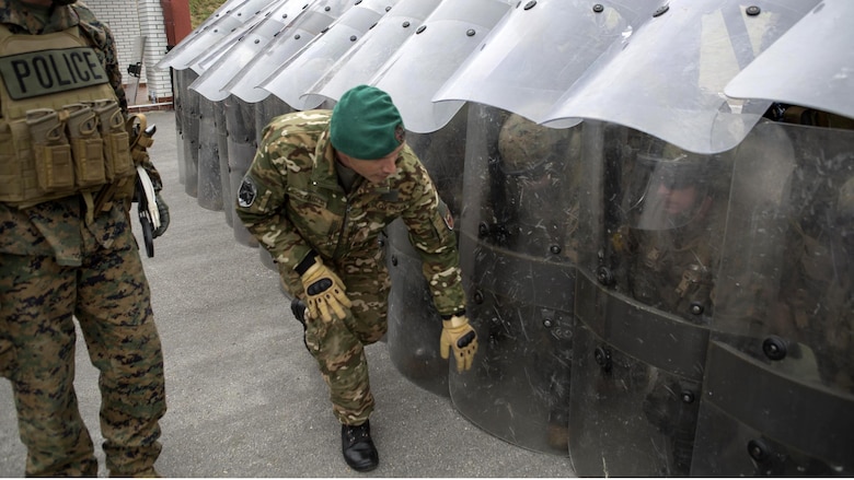Staff Sgt. Ivan Collautti, a military policeman and crowd control instructor from Slovenia, checks the integrity of the defensive shell the Marines of 4th Law Enforcement Battalion, Force Headquarters Group, Marine Forces Reserve, made during exercise Platinum Wolf 2016 at Peacekeeping Training Operations Center South Base in Bujanovac, Serbia, May 12, 2016. Platinum Wolf brings together service members from Bosnia, Bulgaria, Macedonia, Montenegro, Serbia, Slovenia, and the United States to train in peacekeeping operations and non-lethal weapons capabilities. 