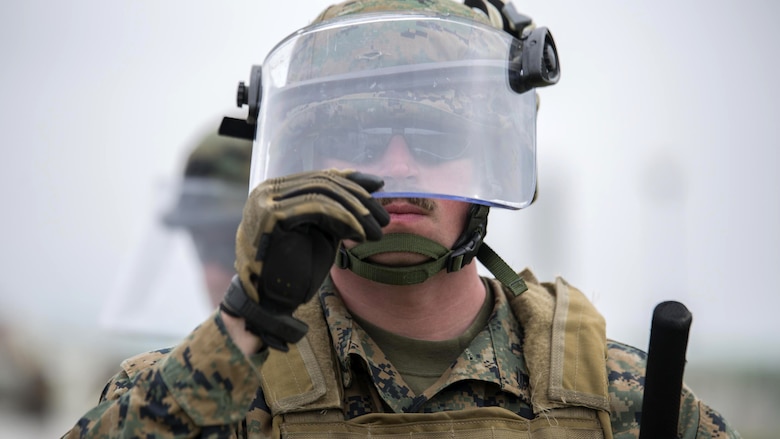 Cpl. Tyrel Phillips, a military policeman with 4th Law Enforcement Battalion, Force Headquarters Group, Marine Forces Reserve, pulls down his visor before presenting his shield while training in a class on crowd control during exercise Platinum Wolf 2016 at Peacekeeping Training Operations Center South Base in Bujanovac, Serbia, May 12, 2016. Platinum Wolf brings together service members from Bosnia, Bulgaria, Macedonia, Montenegro, Serbia, Slovenia, and the United States, it aims to build interoperability between the partnering nations and promote regional stability. 