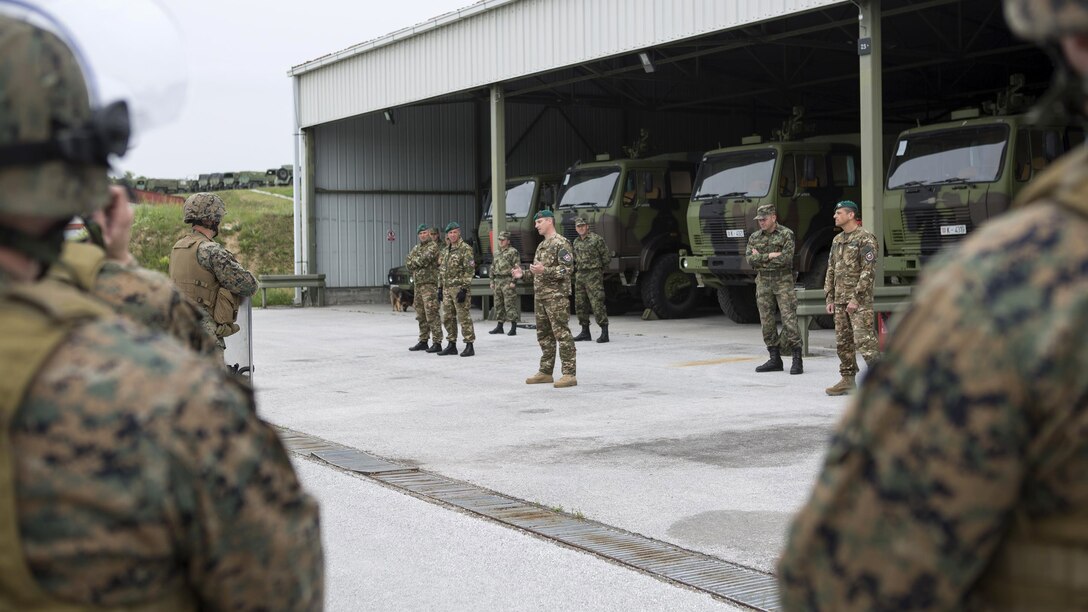 Reserve Marines with 4th Law Enforcement Battalion, Force Headquarters Group, Marine Forces Reserve, listen to classes on crowd control given by Slovenian and Serbian service members during exercise Platinum Wolf 2016 at Peacekeeping Training Operations Center South Base in Bujanovac, Serbia, May 12, 2016. Platinum Wolf brings together service members from Bosnia, Bulgaria, Macedonia, Montenegro, Serbia, Slovenia, and the United States to train in peacekeeping operations and non-lethal weapons capabilities.