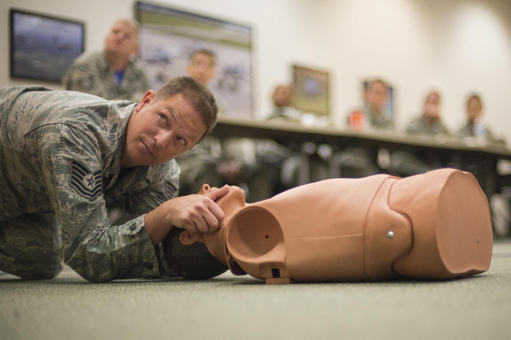 U.S. Air Force Tech. Sgt. Kevin Strickland, 23d Maintenance Operations Flight self-aid buddy care instructor, demonstrates the jaw-thrust technique for clearing an airway, May 13, 2016, at Moody Air Force Base, Ga. Airmen were taught to evaluate a casualty’s airway before deciding which technique to use. (U.S. Air Force photo by Airman Daniel Snider/Released)
