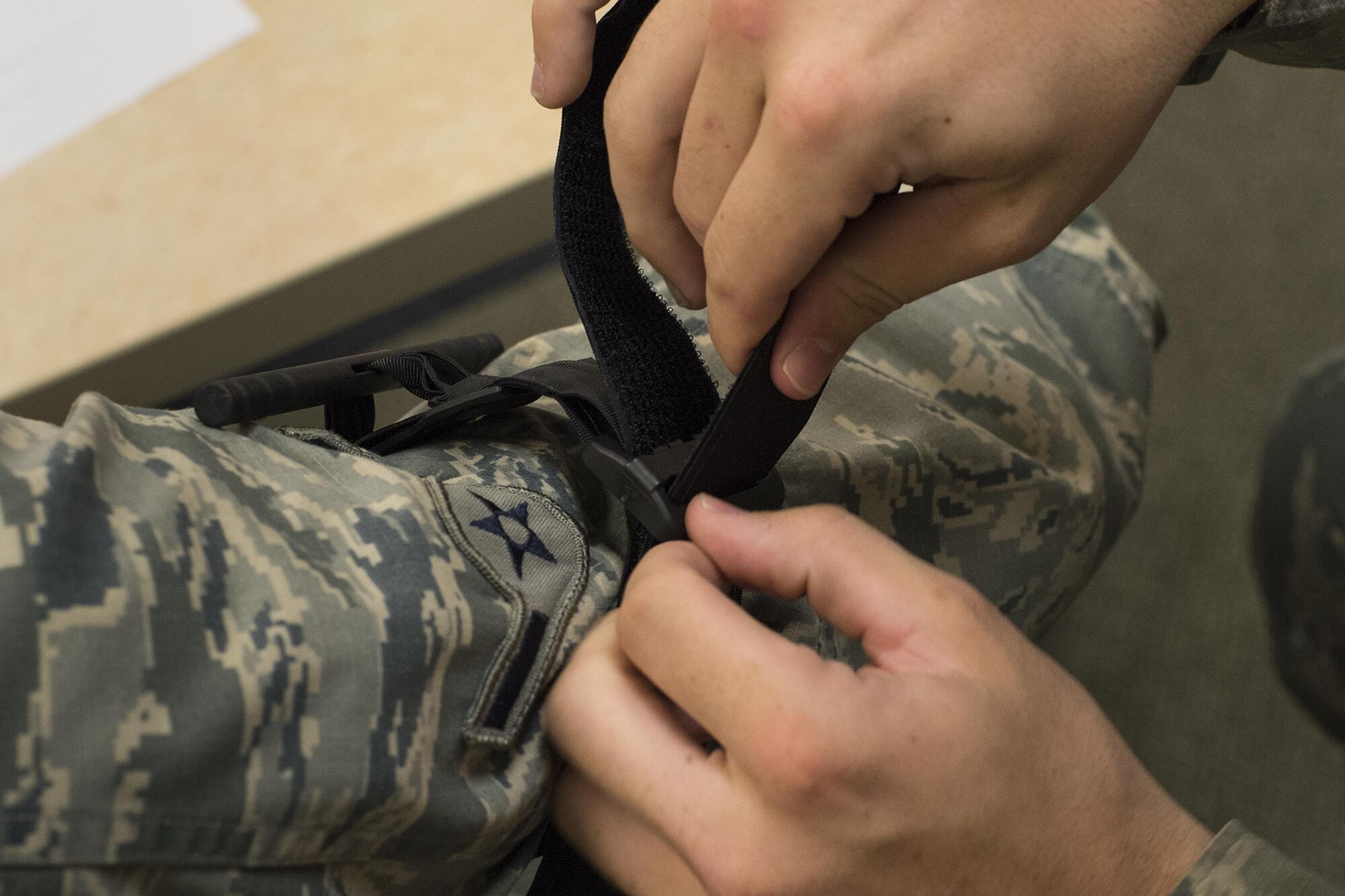 U.S. Air Force Airmen practice correct tourniquet use, May 13, 2016, at Moody Air Force Base, Ga. Tourniquets are placed as high and tight as possible on the injured extremity. (U.S. Air Force photo by Airman Daniel Snider/Released)