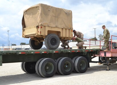 Soldiers from the 729th Transportation Company, Fresno, Calif., and Marines from the 3rd Air Naval Gunfire Liaison Company worked together, loading a M-872 Series 40-foot, 34-ton flatbed semitrailer, with cargo and the equipment, which will be used at Operation Maple Resolve and is being conducted at Canadian Forces Base Wainwright, east of Edmonton, Canada. Operation Maple Resolve is the Canadian Forces largest training exercise of the year.