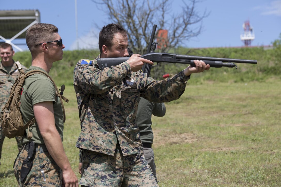 Sgt. Martin Belden, a non-lethal weapons instructor with 4th Law Enforcement Battalion, Force Headquarters Group, Marine Forces Reserve, observes a Bosnian soldier during practical application in a non-lethal weapons course at exercise Platinum Wolf 2016 aboard Peacekeeping Operations Training  Center South Base in Bujanovac, Serbia, May 13, 2016. Seven countries including Bosnia, Bulgaria, Macedonia, Montenegro, Slovenia, Serbia, and the United States joined together to enhance their ability to work together and master the use on non-lethal weapons systems. (U.S. Marine Corps photo by Sgt. Sara Graham)
