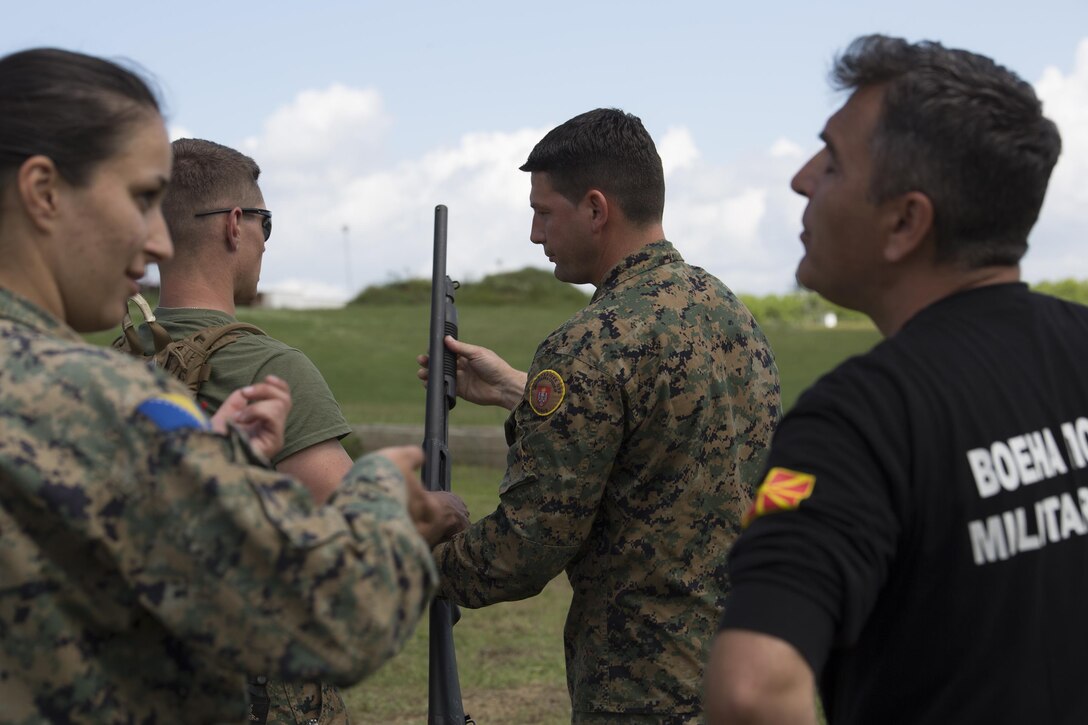 Sgt. Maj. Sasha Toshevski, first sergeant of the Macedonian Special Forces Regiment, instructs a Bosnian solider on shotgun firing techniques while training in a non-lethal weapons class during exercise Platinum Wolf 2016 at Peacekeeping Operations Training  Center South Base in Bujanovac, Serbia, May 13, 2016. Seven countries including Bosnia, Bulgaria, Macedonia, Montenegro, Slovenia, Serbia, and the United States joined together to enhance their ability to work together and master the use on non-lethal weapons systems. (U.S. Marine Corps photo by Sgt. Sara Graham)