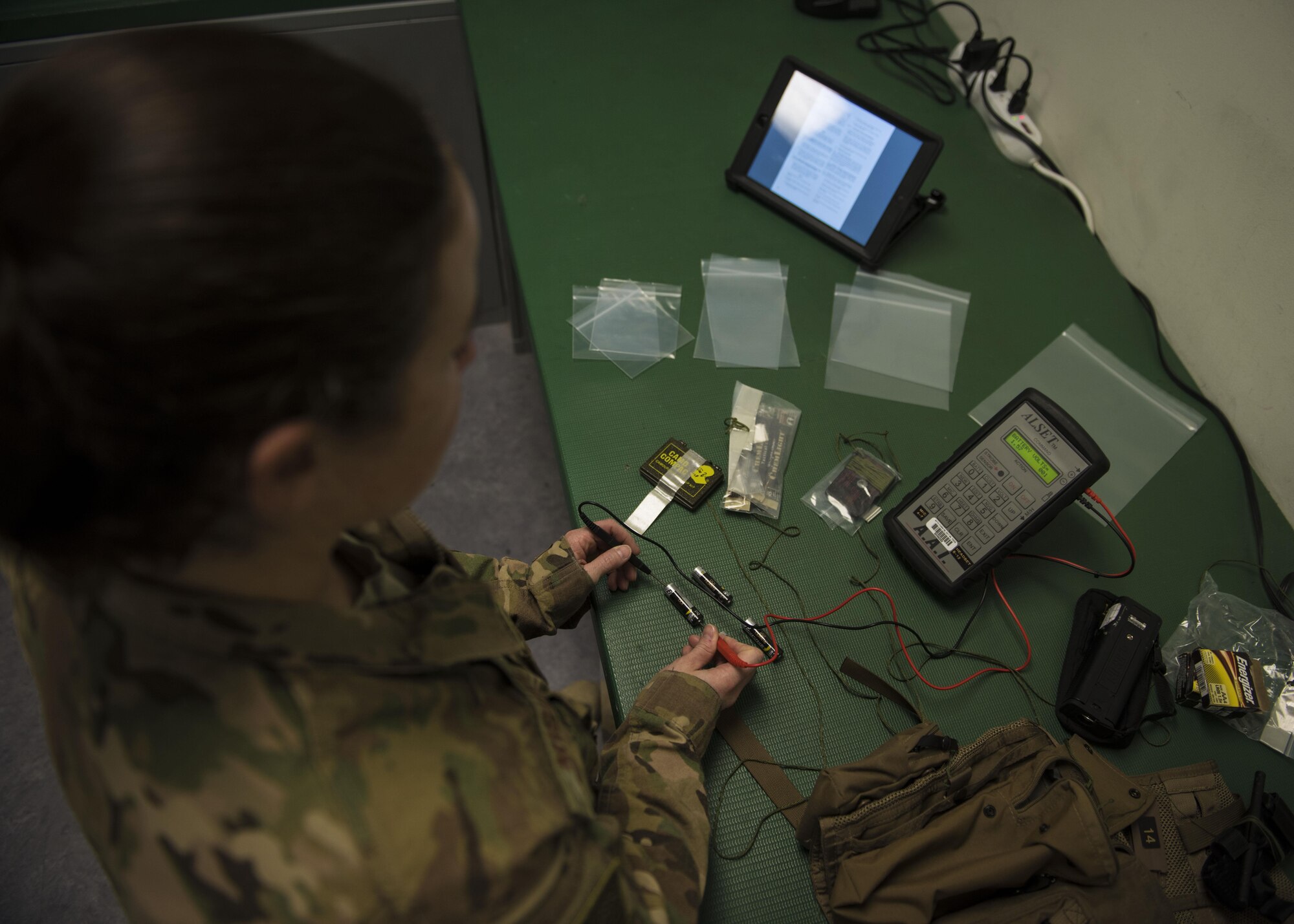 Staff Sgt. Cameran Miguel, 457th Expeditionary Fighter Squadron aircrew flight equipment technician, tests the charge on a battery in a pilot's survival vest at Bagram Airfield, Afghanistan, May 15, 2016. Responsible for ensuring that all flight and safety equipment is in perfect working order, the attention to detail provided by these professionals could mean the difference between life and death. (U.S. Air Force photo by Senior Airman Justyn M. Freeman)