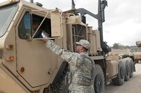 Fort Hunter-Liggett - U.S. Army Reserve avionic mechanic Sgt. Shawn Kennedy from the 351st MP Company, of Ocala, Florida, guard, and check paper work of Soldiers coming and going at Entry Control Point for one of the Forward Operating Bases at Fort Hunter-Liggett, Calif. for training exercise Warrior Exercise 2016 on May 5. The 351st MP Co. is conducting 24 hour operations of the Entry Control Point for the entire duration of WAREX. (U.S. Army photo by Sgt. Marco Gutierrez)
