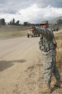 Fort Hunter-Liggett - U.S. Army Reserve avionic mechanic Sgt. Shawn Kennedy from the 351st MP Company, of Ocala, Florida directs traffic through the Entry Control Point for one of the Forward Operating Bases at Fort Hunter-Liggett, Calif. for training exercise Warrior Exercise 2016 on May 5. The 351st MP Co. is conducting 24 hour operations of the Entry Control Point for the entire duration of WAREX. (U.S. Army photo by Sgt. Marco Gutierrez)