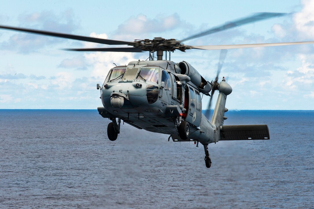 An MH-60S Seahawk helicopter conducts plane guard operations alongside the USS Carl Vinson in the Pacific Ocean, May 6, 2016. The helicopter is assigned to Helicopter Sea Combat Squadron 8. Navy photo by Petty Officer 2nd Class John Philip Wagner Jr.