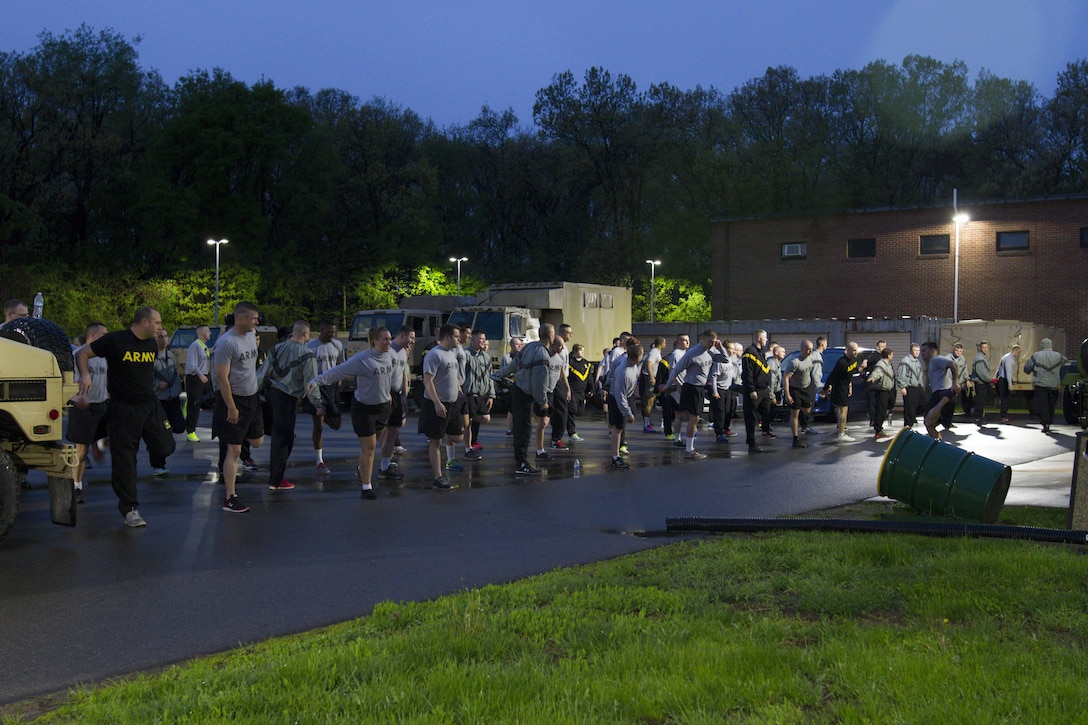 U.S. Army Reserve Soldiers assigned to the 303rd Military Police Company stretch before taking the Army Physical Fitness Test in Jackson, Michigan, May 14. The test is held annually and consists of a two-minute push-up and sit-up events and a timed two-mile run. The test measures the muscular strength and endurance of each Soldier, which ensures they have what it takes to uphold the Army's fitness standard. (U.S. Army photo by Sgt. Audrey Hayes)