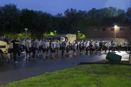 U.S. Army Reserve Soldiers assigned to the 303rd Military Police Company stretch before taking the Army Physical Fitness Test in Jackson, Michigan, May 14. The test is held annually and consists of a two-minute push-up and sit-up events and a timed two-mile run. The test measures the muscular strength and endurance of each Soldier, which ensures they have what it takes to uphold the Army's fitness standard. (U.S. Army photo by Sgt. Audrey Hayes)