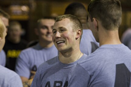 Spc. Cameron Cussen, a U.S. Army Reserve motor transport operator from Garden City, Michigan, assigned to the 303rd Military Police Company, laughs with fellow Soldiers between events during the Army Physical Fitness Test in Jackson, Michigan, May 14. The test is held annually and consists of a two-minute push-up and sit-up events and a timed two-mile run. The events measure the muscular strength and endurance of each Soldier, which ensures they have what it takes to uphold the Army's fitness standard. (U.S. Army photo by Sgt. Audrey Hayes)