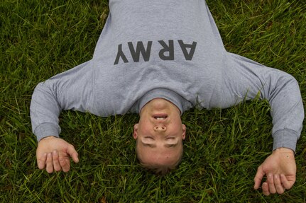 Cpl. Dillon Stuart, a U.S. Army Reserve Military Police from Mason, Michigan, assigned to the 303rd MP Company, recovers from a two-mile run during the Army Physical Fitness Test in Jackson, Michigan, May 14. The test is held annually for reservists, and consists of a two-minute push-up and sit-up event and a timed two-mile run. The events measure the muscular strength and endurance of each Soldier, which ensures they have what it takes to uphold the Army's fitness standard. (U.S. Army photo by Sgt. Audrey Hayes)