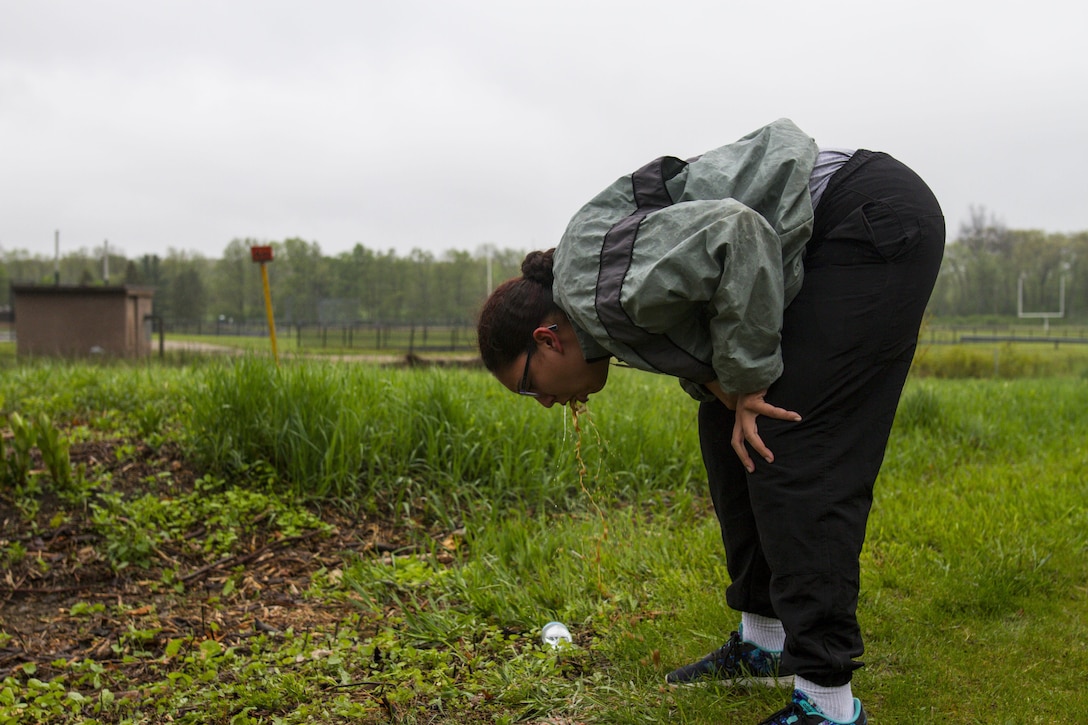 Pfc. Karina Iannicello, a U.S. Army Reserve Military Police from Detroit, Michigan, assigned to the 303rd Military Police Company, vomits after a two-mile run during the Army Physical Fitness Test in Jackson, Michigan, May 14. The test is held annually and consists of a two-minute push-up and sit-up events and a timed two-mile run. The events measure the muscular strength and endurance of each Soldier, to ensure they have what it takes to uphold the Army's fitness standard. (U.S. Army photo by Sgt. Audrey Hayes)