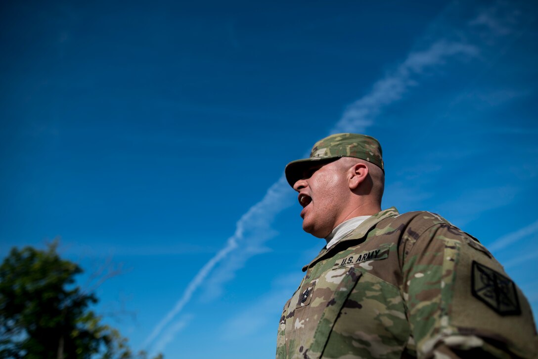 A U.S. Army Reserve noncommissioned officer from the 200th Military Police Command's headquarters company shouts out the lap time to runners participating in the Army Physical Fitness Test, May 14, during battle assembly at Fort Meade, Maryland. (U.S. Army photo by Master Sgt. Michel Sauret)