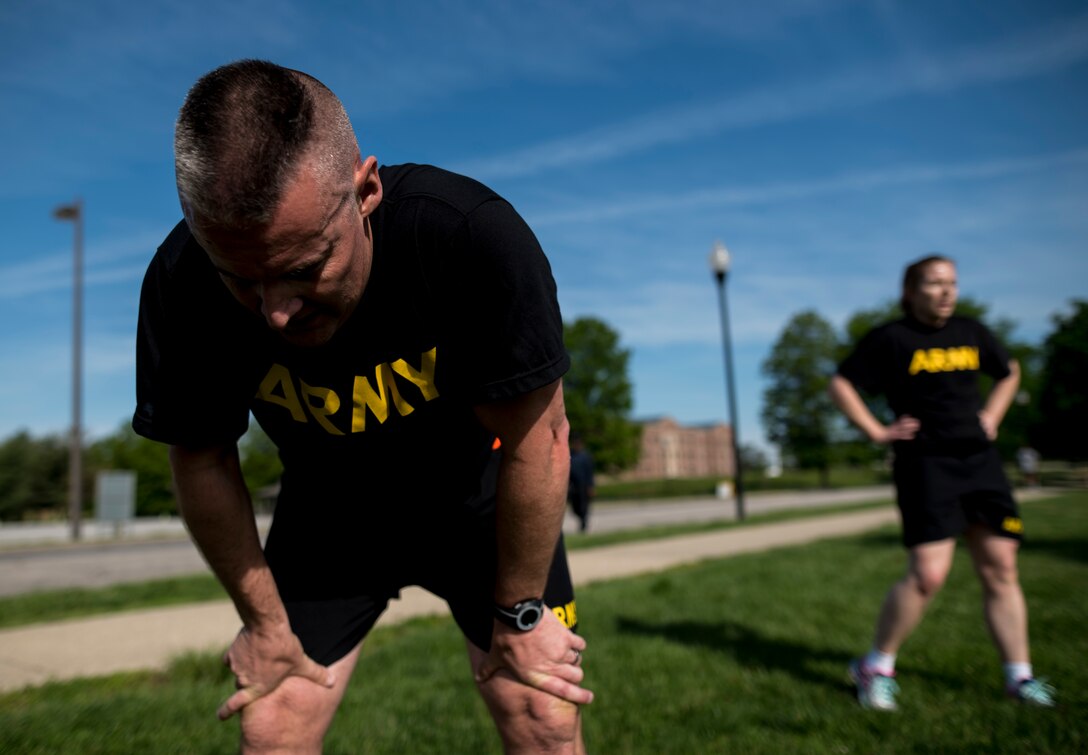 Maj. John Mullaney, U.S. Army Reserve commander of the 200th Military Police Command's headquarters company, and another Soldier, take a breather after completing a two-mile run as part of the Army Physical Fitness Test, May 14, during battle assembly at Fort Meade, Maryland. (U.S. Army photo by Master Sgt. Michel Sauret)