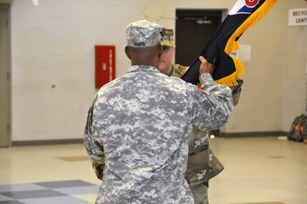 Col. James White Jr., the interim commander of the Atlantic Division, 75th Training Command, passes the guidon to Col. Joseph Lestorti, incoming brigade commander for the division's 3rd Brigade during a change-of-command ceremony May 14 at Joint Base McGuire-Dix-Lakehurst, New Jersey.