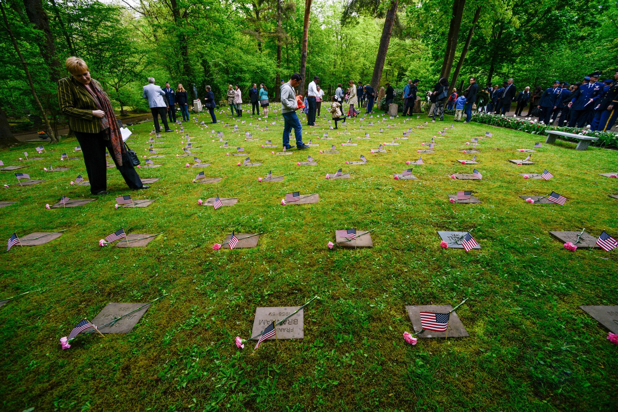 Kaiserslautern Military Community members view the gravestones of deceased children after the Kindergraves Memorial Service May 14, 2016, Kaiserslautern Military Cemetery, Germany.  The ceremony is held annually to honor the children who were lost during the Cold War, that were mainly infants who died of complications before reaching their first birthday.  (U.S. Air Force photo/Senior Airman Nicole Keim)