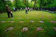 Kaiserslautern Military Community members view the gravestones of deceased children after the Kindergraves Memorial Service May 14, 2016, Kaiserslautern Military Cemetery, Germany.  The ceremony is held annually to honor the children who were lost during the Cold War, that were mainly infants who died of complications before reaching their first birthday.  (U.S. Air Force photo/Senior Airman Nicole Keim)