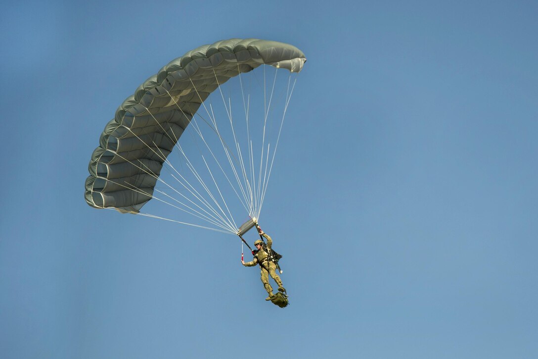 A pararescueman descends after jumping from a C-130J Super Hercules aircraft during a mission rehearsal at Bagram Airfield, Afghanistan, April 28, 2016. The pararescuemen are assigned to the 83rd Expeditionary Rescue Squadron. Air Force photo by Tech. Sgt. Robert Cloys