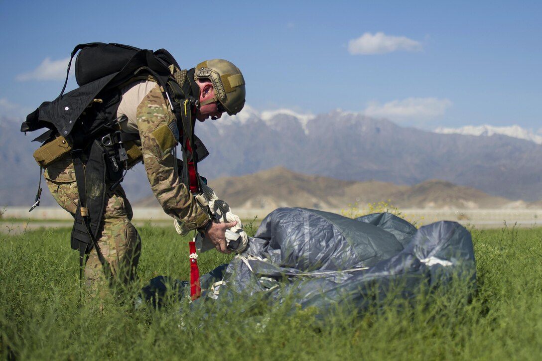 A pararescueman recovers the parachute after jumping from a C-130J Super Hercules aircraft during a mission rehearsal at Bagram Airfield, Afghanistan, April 28, 2016. Air Force photo by Tech. Sgt. Robert Cloys