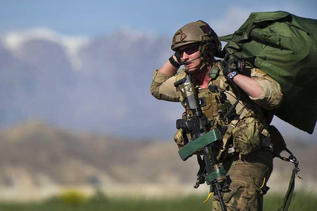 A pararescueman carries gear to the rally point after jumping from a C-130J Super Hercules aircraft during a mission rehearsal at Bagram Airfield, Afghanistan, April 28, 2016. Air Force photo by Tech. Sgt. Robert Cloys