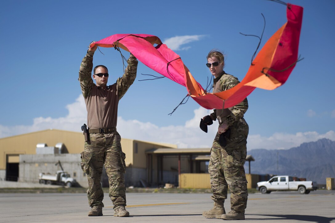 Pararescuemen lay visual panels while team members prepare to jump from a C-130J Super Hercules aircraft during a mission rehearsal at Bagram Airfield, Afghanistan, April 28, 2016. Air Force photo by Tech. Sgt. Robert Cloys