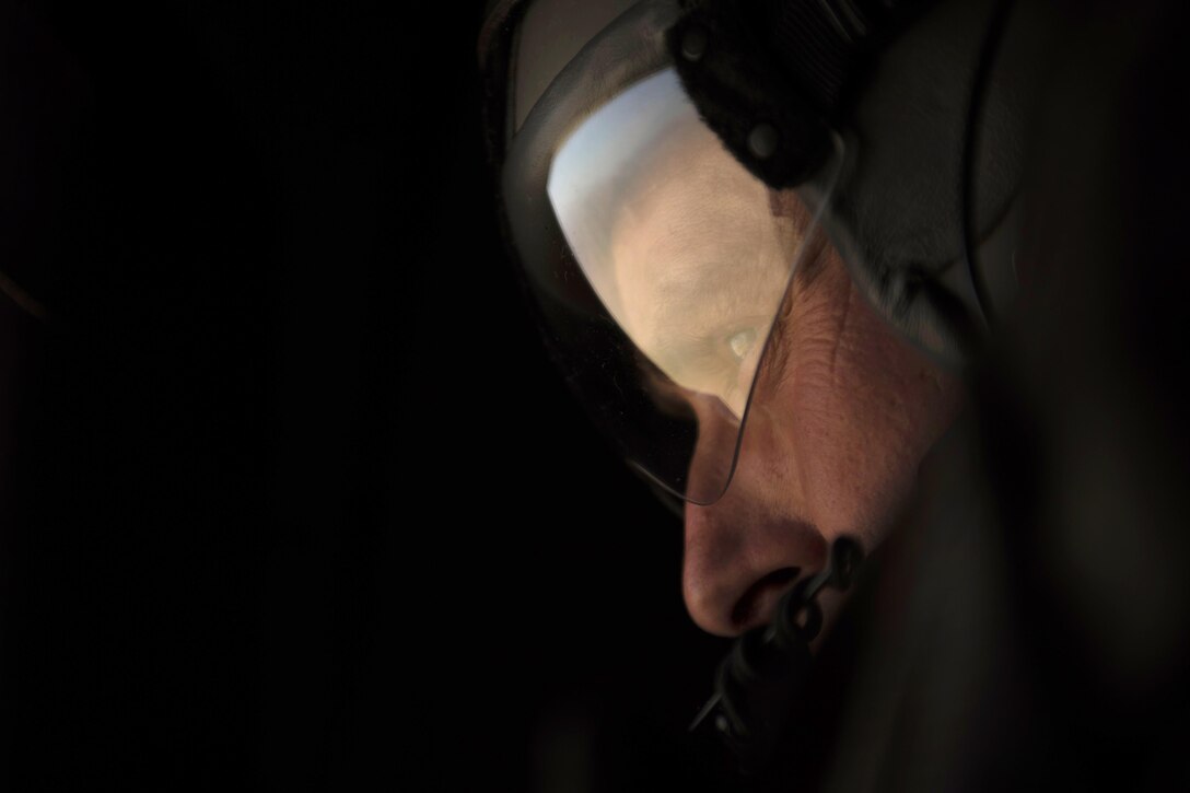 Air Force Senior Master Sgt. Kevin Letz keeps an eye out while pararescuemen jump from a C-130J Super Hercules aircraft during a mission rehearsal at Bagram Airfield, Afghanistan, April 28, 2016. Letz is a loadmaster assigned to the 774th Expeditionary Airlift Squadron. Air Force photo by Senior Airman Justyn M. Freeman