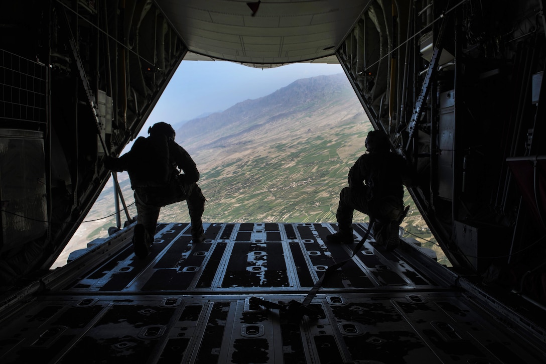 Air Force loadmasters watch pararescuemen descend to the drop zone after jumping from a C-130J Super Hercules aircraft during a mission rehearsal at Bagram Airfield, Afghanistan, April 28, 2016. Air Force photo by Senior Airman Justyn M. Freeman