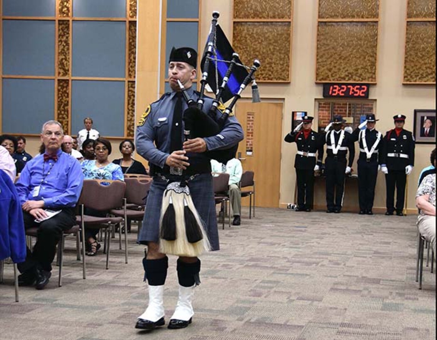 Virginia State Trooper Gavin Scott plays “Amazing Grace” on the bagpipe at the conclusion of the ceremony held at the Lotts Conference Center on Defense Supply Center Richmond, Virginia, May 12, 2016. 
