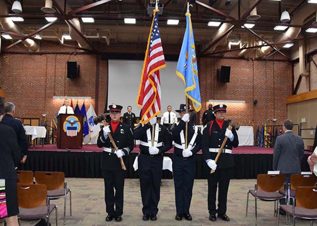 The honor guard comprising Defense Logistics Agency Installation Support at Richmond firefighters and police officers moves to retire the colors at the conclusion of the Peace Officers' Memorial Day observation at the Lotts Conference Center on Defense Supply Center Richmond, Virginia, May 12, 2016. 