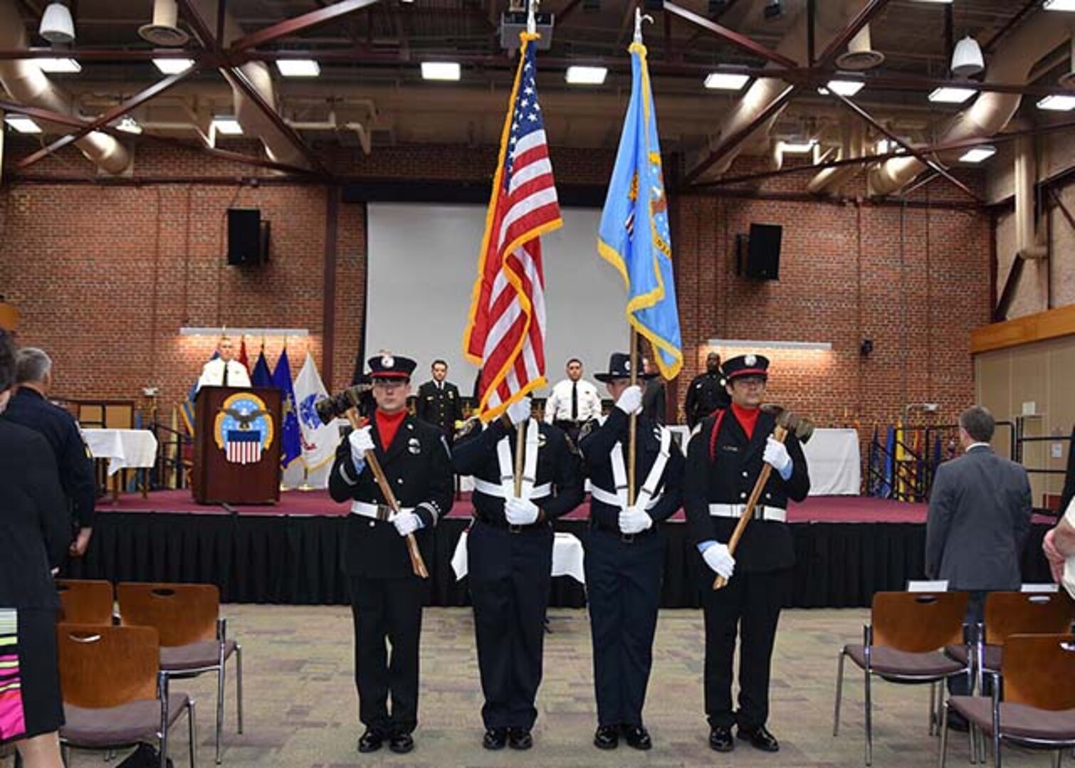 The honor guard comprising Defense Logistics Agency Installation Support at Richmond firefighters and police officers moves to retire the colors at the conclusion of the Peace Officers' Memorial Day observation at the Lotts Conference Center on Defense Supply Center Richmond, Virginia, May 12, 2016. 