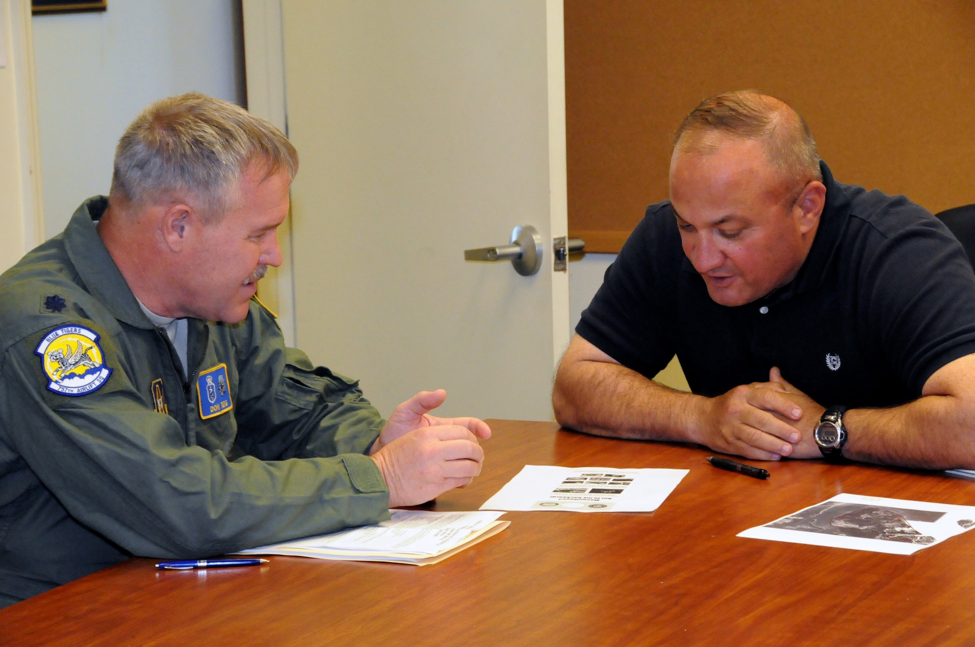 Lt. Col. Don Teig, a medical entomologist assigned to the 757th Airlift Squadron, discusses the upcoming aerial spray mission with Bill Tate, the Marine Corps Recruit Depot’s Deputy G-4 here, April 5, 2016. The aerial spray flight from Youngstown Air Reserve Station's 910th Airlift Wing came to spray noseeums,  small blood-sucking gnats, which are a major nuisance in the area. The mission is a nighttime aerial spray which has been found to be the most effective way to target the noseeums. Last year’s missions showed a control rate between 90 and 100 percent; 80 percent is considered successful mission.  (U.S. Air Force photo/ Tech. Sgt. Rick Lisum)