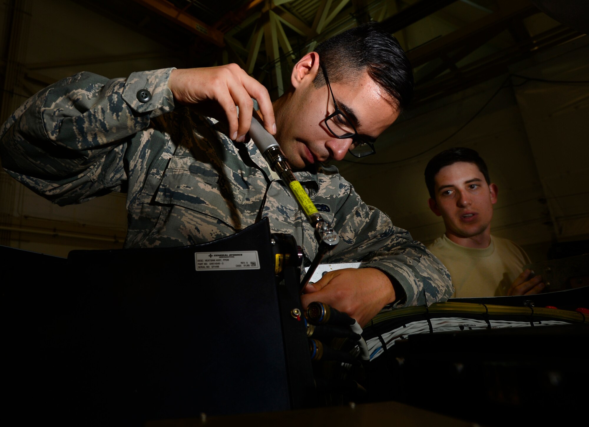 Airman Troy, left, and Staff Sgt. Marshall, both 432nd Aircraft Maintenance Squadron avionics specialists, train on removing a control box, May 11, 2016, at Creech Air Force Base, Nevada. On August 31, 1949, Secretary of Defense Louis Johnson announced the creation of an Armed Forces Day to replace separate Army, Navy, Marine Corps and Air Force Days.  (U.S. Air Force photo by Senior Airman Christian Clausen/Released)