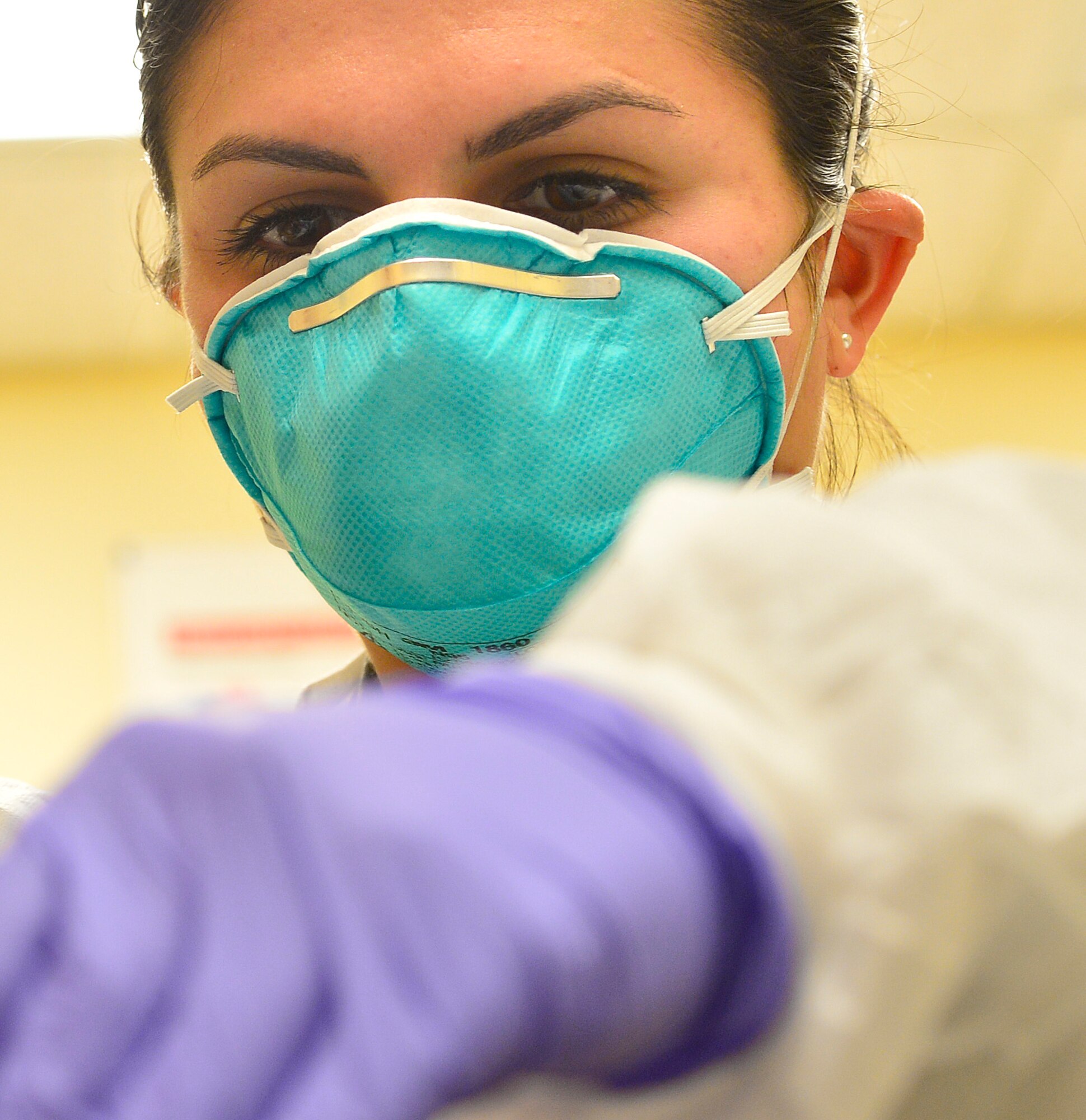 Airman 1st Class Tiffany, 99th Medical Operations Squadron medical technician examines a training dummy’s wounds April 13, 2016, at Creech Air Force Base, Nevada. On August 31, 1949, Secretary of Defense Louis Johnson announced the creation of a single day of recognition replacing separate Army, Navy, Marine Corps and Air Force observances. U.S. Air Force photo by Senior Airman Christian Clausen/Released)