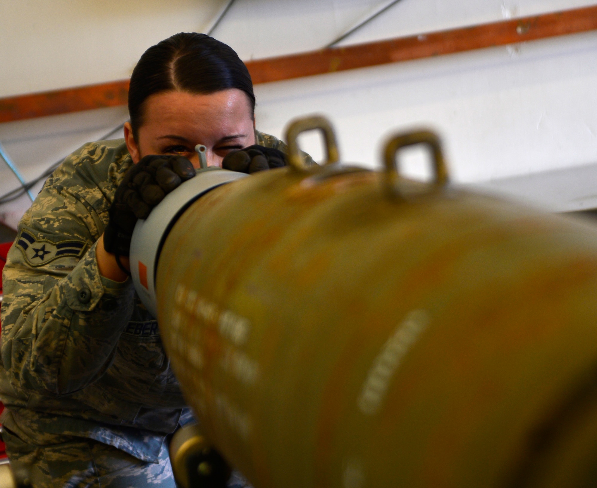 Airman 1st Class Karen, 432nd Maintenance Squadron munitions flight crew members, inspects a GBU-12 Paveway II laser-guided bomb during a build March 1, 2016, at Creech Air Force Base, Nevada. On August 31, 1949, Secretary of Defense Louis Johnson announced the creation of an Armed Forces Day to replace separate Army, Navy, Marine Corps and Air Force Days.  (U.S. Air Force photo by Senior Airman Christian Clausen/Released)