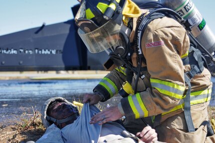 JOLON, Calif. – A Fire fighting Soldier with the 614th Engineer Detachment evaluates a simulated casualty during a multi-unit mass casualty exercise at Fort Hunter Liggett’s Tusi Airfield, May 9. The exercise was apart of the Fort’s 16th Annual Warrior Exercise and the scenario encompassed a simulated helicopter crash, which had burst into flames and 32 casualties laid scattered around the helicopter. (U.S. Army photo by Sgt. Kimberly Browne, 350th Public Affairs Detachment)