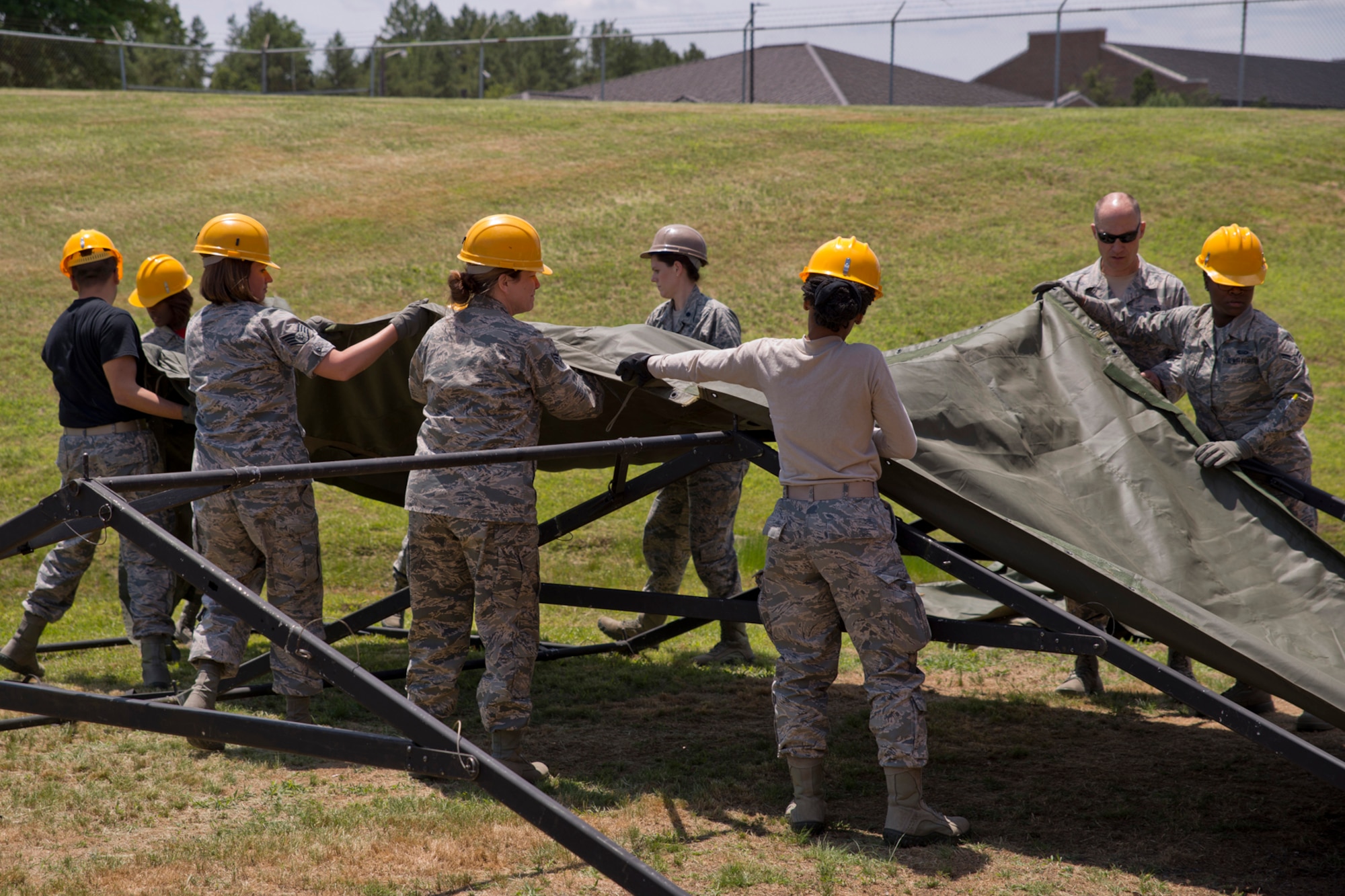 U.S. Air Force Reserve Airmen assigned to the 913th Force Support Squadron, cover the roof of tent frame while participate in tent-building training during the 913th Airlift Group’s Unit Training Assembly weekend at Little Rock AFB, Ark., May 15, 2016. The hands-on training, which is required every 20 months, gives the Airmen experience with the equipment in the event they are deployed to a location with little or no support. (U.S. Air Force photo by Master Sgt. Jeff Walston/Released) 