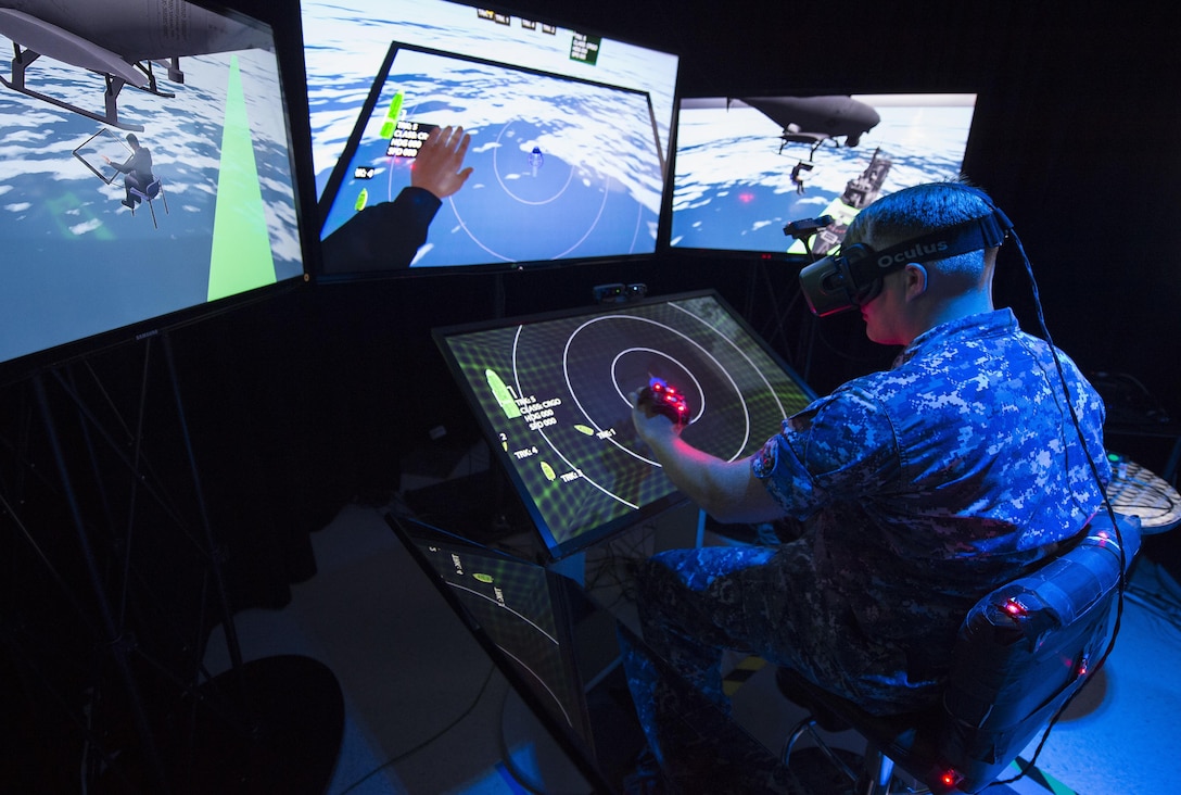 Navy Lt. Jeff Kee explores the Office of Naval Research-sponsored Battlespace Exploitation of Mixed Reality Lab at Space and Naval Warfare Systems Center Pacific, San Diego, Sept. 14, 2015. BEMR is designed to showcase and demonstrate cutting-edge, low-cost, commercial-mixed reality, virtual reality and augmented reality technologies. It also provides a facility where warfighters, researchers, government, industry and academia can collaborate. Navy photo by John F. Williams 