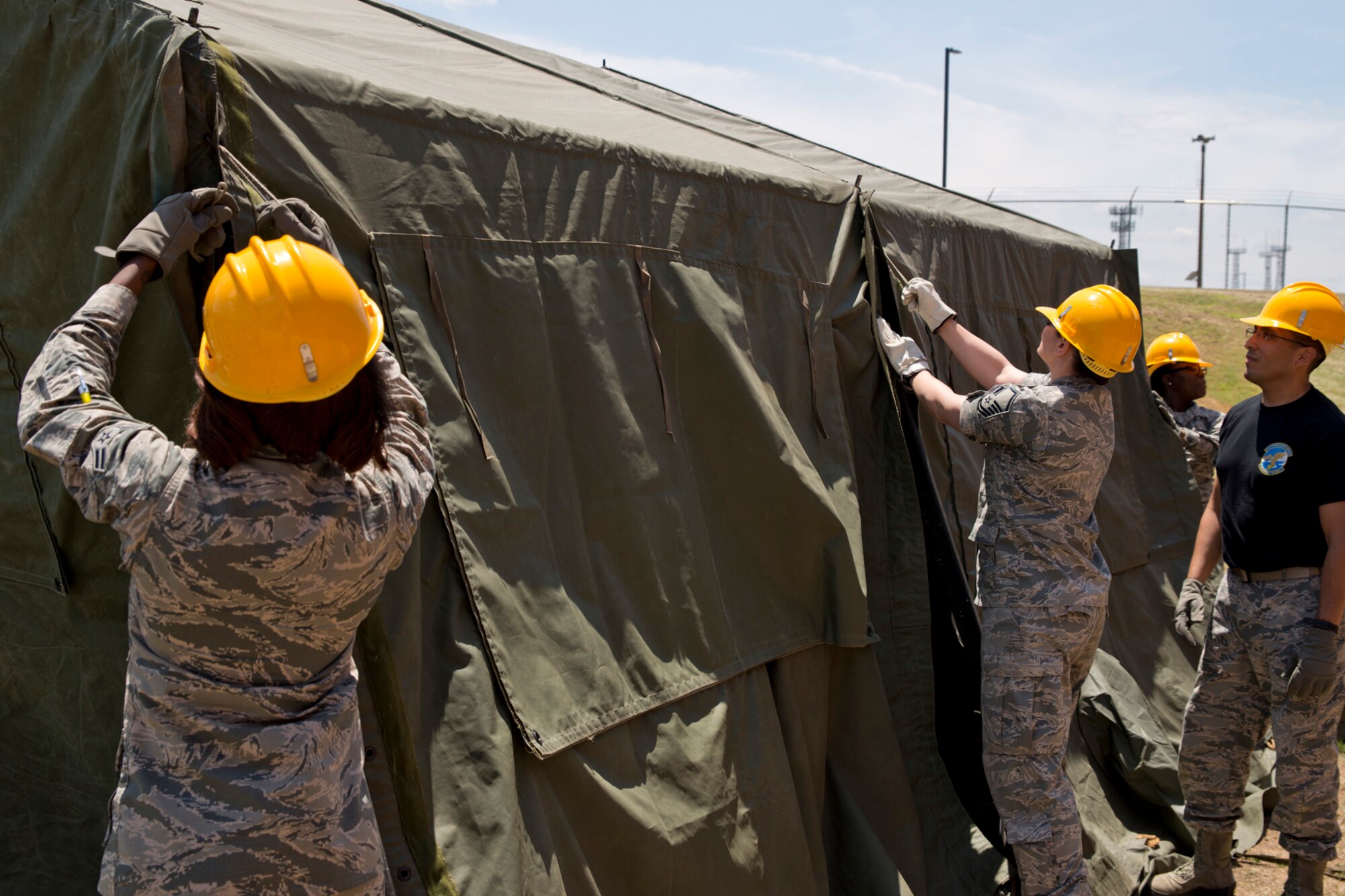 U.S. Air Force Reserve Airmen assigned to the 913th Force Support Squadron, secure sections of tarp to a frame while participating in tent-building training during the 913th Airlift Group’s Unit Training Assembly weekend at Little Rock AFB, Ark., May 15, 2016. The hands-on training, which is required every 20 months, gives the Airmen experience with the equipment in the event they are deployed to a location with little or no support. (U.S. Air Force photo by Master Sgt. Jeff Walston/Released) 