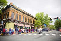 Col. Kevin Gordon, 436th Airlift Wing vice commander, marches with his family and Col. Eric Brandes, 512th Maintenance Group commander and his wife, as they lead the parade May 8, 2016, during the Old Dover Days parade in downtown Dover, Del. Old Dover Days is a celebration of Delaware’s history as the first state. (U.S. Air Force photo/Capt. Bernie Kale)