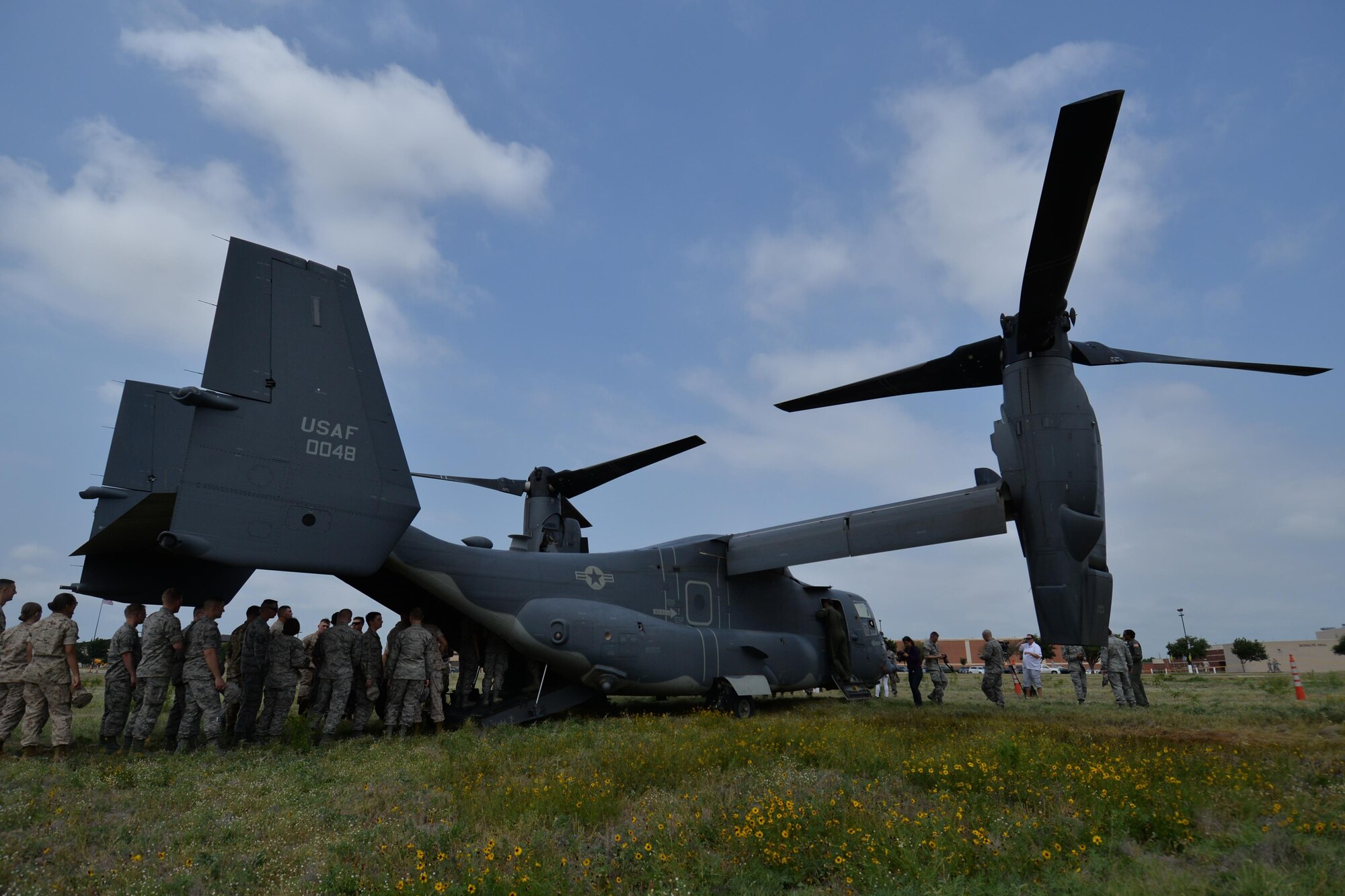 17th Training Wing intelligence students tour a CV-22 Osprey assigned to the 20th Special Operations Squadron, Goodfellow Air Force Base, Texas, May 13, 2016. The CV-22 Osprey is a tiltrotor aircraft that combines the vertical takeoff, hover and vertical landing qualities of a helicopter with the long-range, fuel efficiency and speed characteristics of a turboprop aircraft. Its mission is to conduct long-range infiltration, exfiltration and resupply missions for special operations forces. (U.S. Air Force photo by Airman 1st Class Randall Moose/Released)