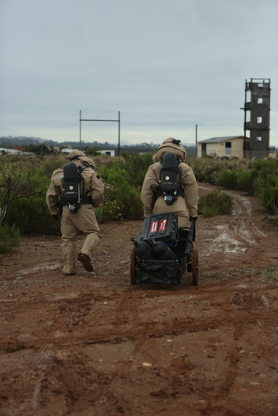 Marines with the Chemical Biological Radiological and Nuclear (CBRN) unit walk to the contamination area during Assessment Consequence Management training  aboard Marine Corps Air Station Miramar, Calif., May 6. The ACM training is conducted by CBRN once a month to maintain mission readiness. (U.S. Marine Corps photo by Pfc. Liah Kitchen/Released)