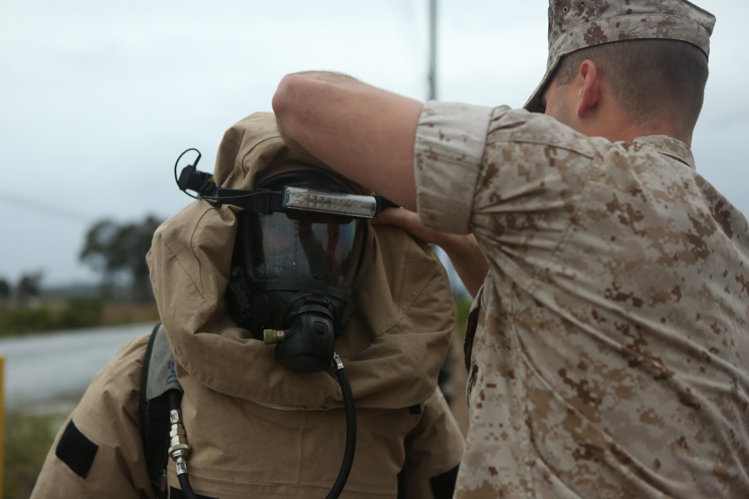 A Marine with the Chemical Biological Radiological and Nuclear (CBRN) unit adjusts another Marine’s hazardous material suit during Assessment Consequence Management training aboard Marine Corps Air Station Miramar, Calif., May 6. The ACM training is conducted by CBRN once a month to maintain mission readiness. (U.S. Marine Corps photo by Pfc. Liah Kitchen/Released)