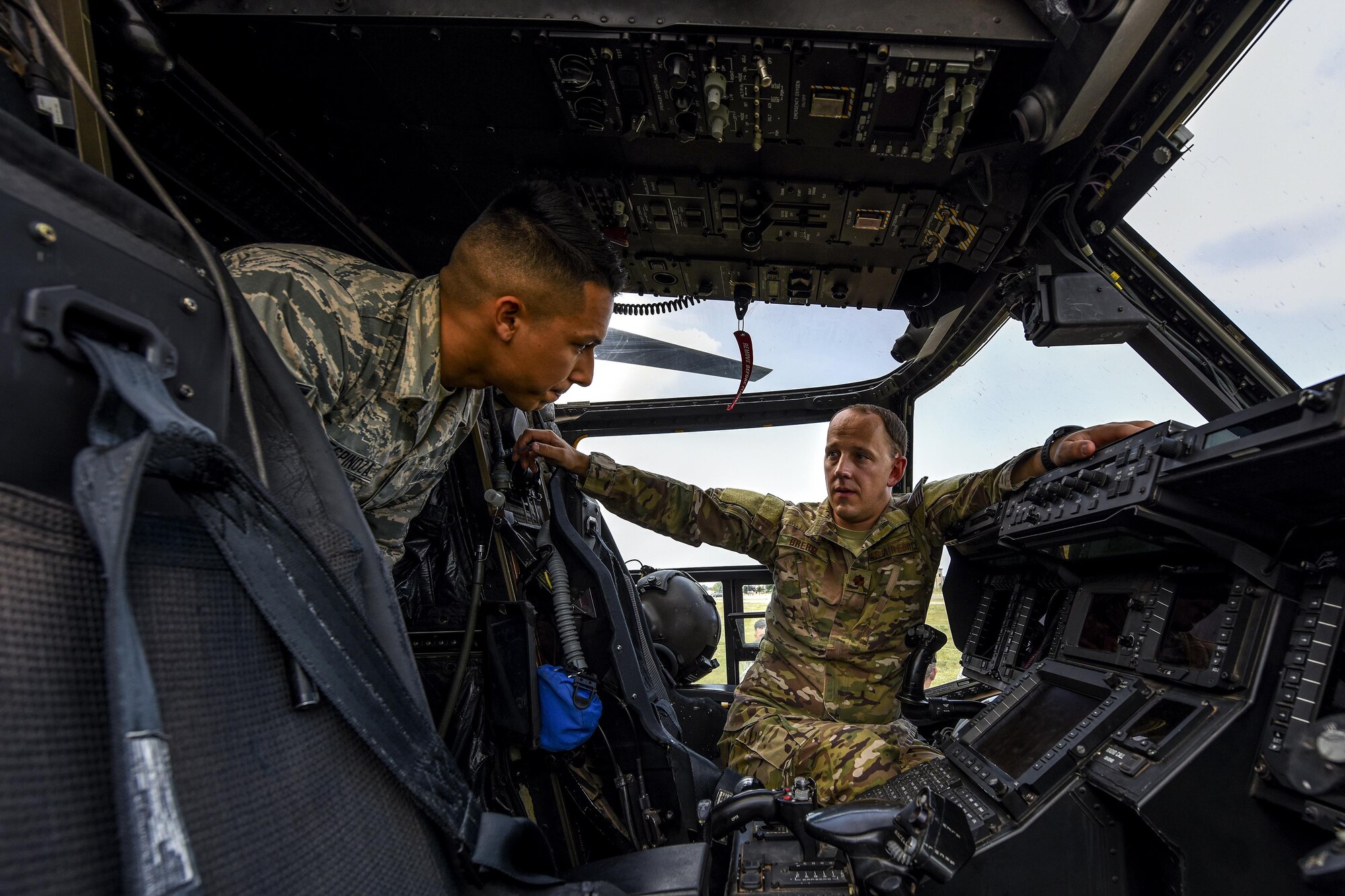 U.S. Air Force Maj. Paul Brehm, 20th Special Operations Squadron, right, talks to a 17th Training wing student inside a CV-22 Osprey cockpit on Goodfellow Air Force Base, Texas, May 13, 2016. Brehm explained the inner workings of the aircraft and the missions it supports. (U.S. Air Force photo by Senior Airman Devin Boyer/Released)