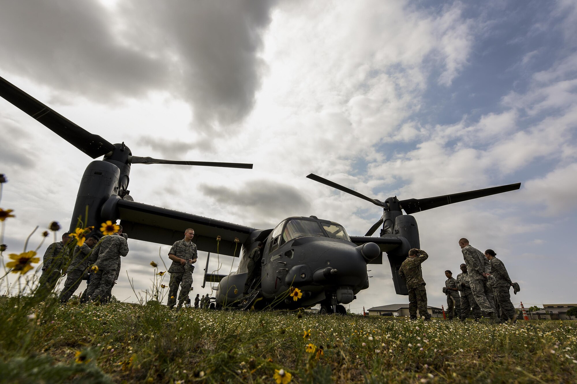 17th Training Wing students and Cannon Air Force Base personnel engage in discussion around a CV-22 Osprey on Goodfellow Air Force Base, Texas, May 13, 2016. Airmen from Cannon flew in on the aircraft to share their knowledge about the operational Air Force with the students. (U.S. Air Force photo by Senior Airman Devin Boyer/Released)