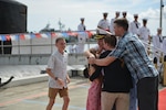 PEARL HARBOR Hawaii (May 13, 2016) Commander Andrew T. Miller, from Hilton Head, S.C., commanding officer of the Los Angeles-class fast-attack submarine USS Charlotte (SSN 766), is greeted by his children upon returning to Joint Base Pearl Harbor-Hickam following a six-month deployment to the Western Pacific. (U.S. Navy photo by Mass Communication Specialist 2nd Class Michael H. Lee/Released)