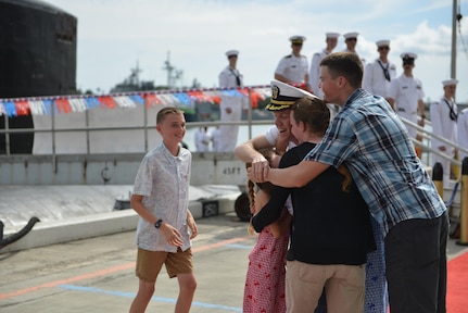 PEARL HARBOR Hawaii (May 13, 2016) Commander Andrew T. Miller, from Hilton Head, S.C., commanding officer of the Los Angeles-class fast-attack submarine USS Charlotte (SSN 766), is greeted by his children upon returning to Joint Base Pearl Harbor-Hickam following a six-month deployment to the Western Pacific. (U.S. Navy photo by Mass Communication Specialist 2nd Class Michael H. Lee/Released)