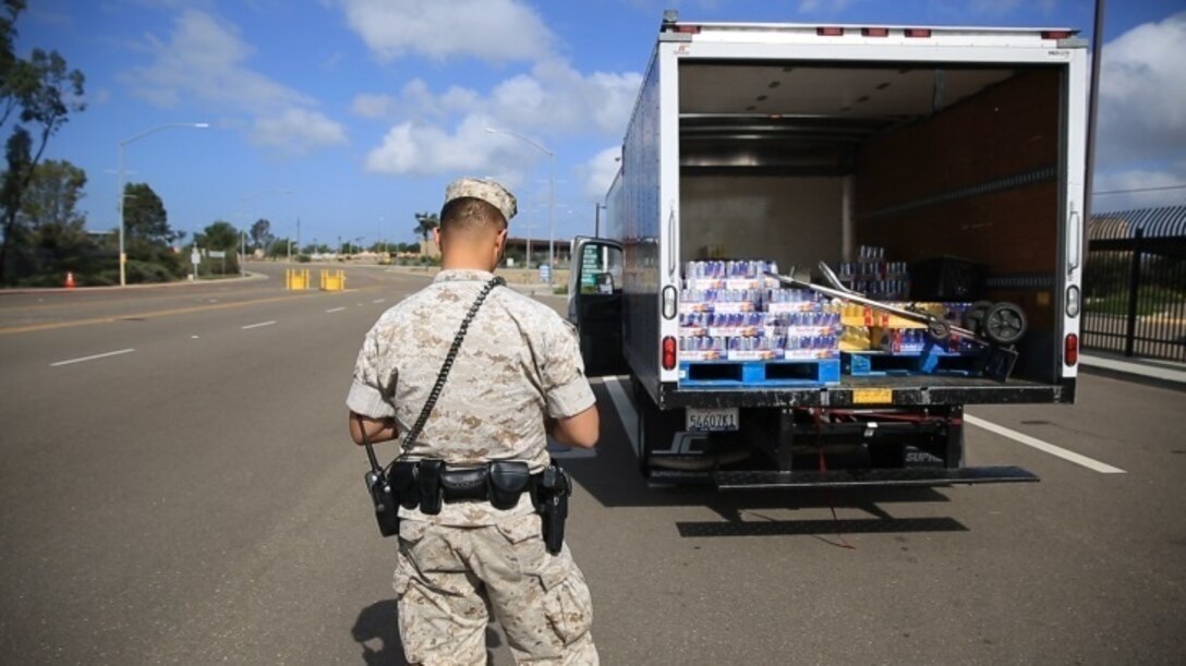 Cpl. Siheng Yang, a military police officer with the Provost Marshal’s Office, prepares to inspect a vehicle aboard Marine Corps Air Station Miramar, Calif., March 22. Vehicle inspections are a vital part of base safety and security, according to Yang. (U.S. Marine Corps photo by Sgt. Michael Thorn/Released)