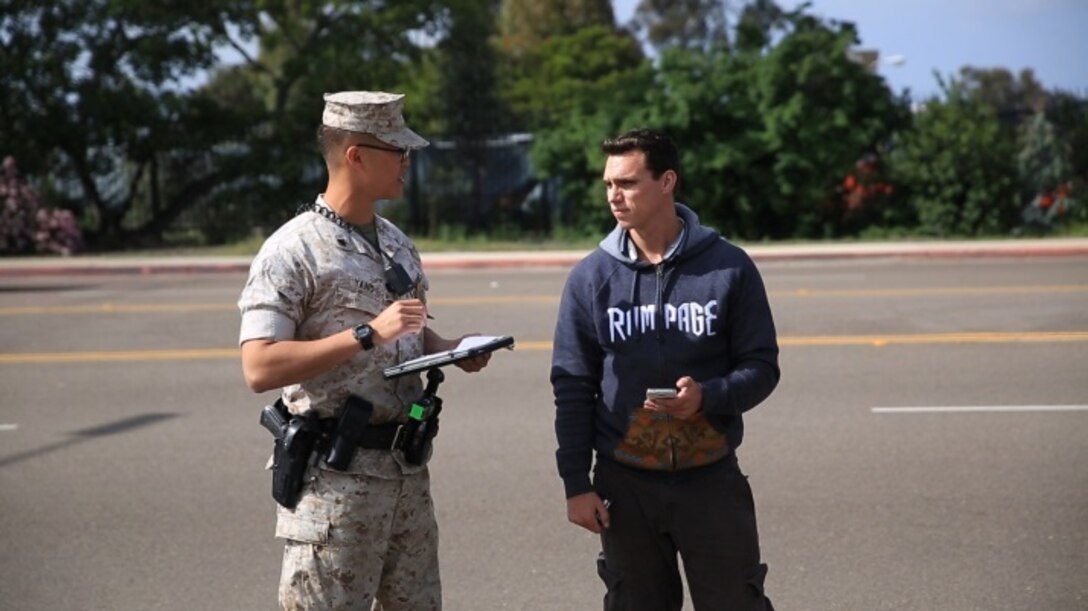 Cpl. Siheng Yang, a military police officer with the Provost Marshal’s Office, discusses the vehicle inspection procedure with a commercial vehicle driver aboard Marine Corps Air Station Miramar, Calif., March 22. The vehicle inspection process is necessary to ensure there is nothing suspicious coming onto the installation, according to Yang. (U.S. Marine Corps photo by Sgt. Michael Thorn/Released)